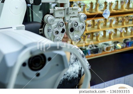 Phoropter for eye test, lenses glasses for eye check in optical store.  136393355