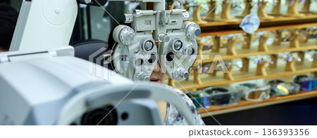 Phoropter for eye test, lenses glasses for eye check in optical store.  136393356