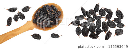 Black raisin iin wooden spoon solated on white background . Top view. Flat lay 136393649