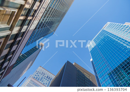 Landscape of the office town looking up at a skyscraper Landscape of the office town looking up at a skyscraper 136393704