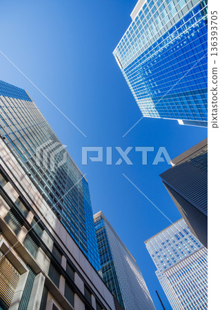 Landscape of the office town looking up at a skyscraper Landscape of the office town looking up at a skyscraper 136393705