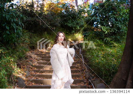 A woman walking in green A woman walking in green 136394114