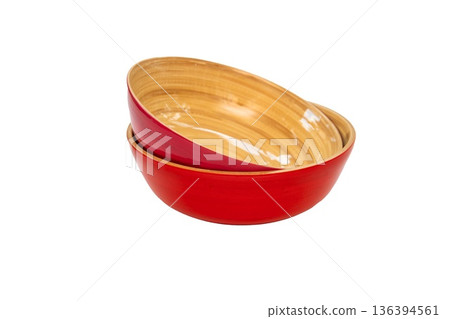 Two red ceramic bowls are stacked together on an isolated background. 136394561
