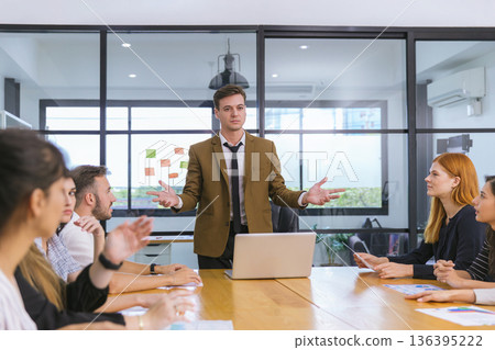 Diverse colleagues gather in brainstorm discuss statistics together. Diverse colleagues gather in brainstorm discuss statistics together. 136395222