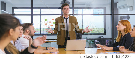 Diverse colleagues gather in brainstorm discuss statistics together. Diverse colleagues gather in brainstorm discuss statistics together. 136395223