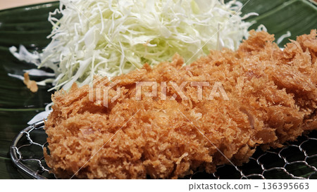 Pork cutlet and shredded cabbage on a plate 136395663