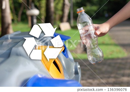Close up of person recycling plastic bottle with recycle symbol overlay, eco-friendly lifestyle concept. Close up of person recycling plastic bottle with recycle symbol overlay, eco-friendly lifestyle concept. 136396076