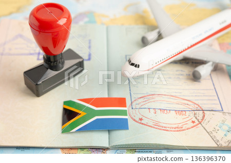 Approved Stamp visa and passport with South Africa flag document to immigration at airport in country. Approved Stamp visa and passport with South Africa flag document to immigration at airport in country. 136396370