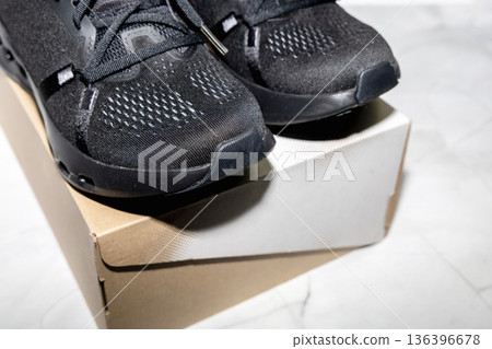 Performance running sneakers presented with simple shoe box. Performance running sneakers presented with simple shoe box. 136396678