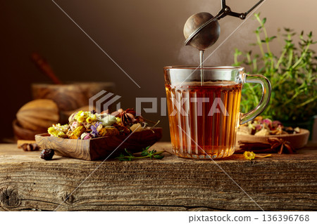 Herbal tea with ingredients on a old wooden table. 136396768