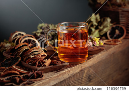 Herbal tea with various dried ingredients on an old wooden table. 136396769