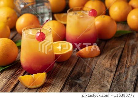 Tequila sunrise cocktail on an old wooden table. 136396772