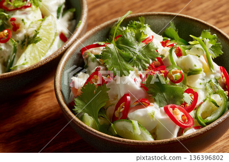 A close-up of freshly prepared "Kokoda" (Fijian ceviche), with coconut cream and lime, garnished with fresh coriander and chili. A close-up of freshly prepared "Kokoda" (Fijian ceviche), with coconut cream and lime, garnished with fresh coriander and chili. 136396802