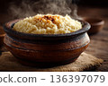 A close-up of Malawian Nsima (thick porridge), steaming hot and served in a traditional bowl, emphasizing the staple food's texture. 136397079
