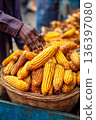 A close-up of Malawian street food: roasted maize cobs, being sold by a roadside vendor, emphasizing popular local snacks. 136397080