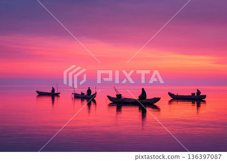 The serene scene of traditional Malawian fishing boats (dugout canoes), gently floating on the calm, vast expanse of Lake Malawi at sunrise. The serene scene of traditional Malawian fishing boats (dugout canoes), gently floating on the calm, vast expanse of Lake Malawi at sunrise. 136397087