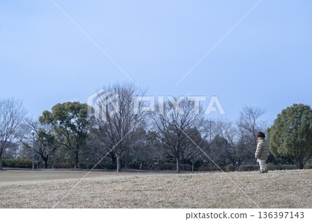 A child standing alone in the park 136397143