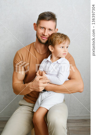 Smiling Father Hugging Son At Home Smiling Father Hugging Son At Home 136397304
