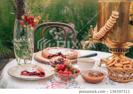 Traditional Outdoor Tea with Samovar, Pie and Strawberries Traditional Outdoor Tea with Samovar, Pie and Strawberries 136397311