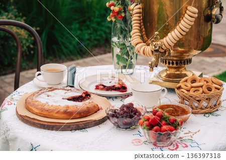 Traditional Outdoor Tea with Samovar, Pie and Strawberries Traditional Outdoor Tea with Samovar, Pie and Strawberries 136397318