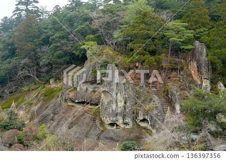 A view of a rocky mountain with a small shrine and a torii gate A view of a rocky mountain with a small shrine and a torii gate 136397356