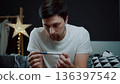 A portrait of a man in deep despair clutching a pregnancy test. The image captures a moment of intense emotional breakdown and mental exhaustion regarding family news 136397542
