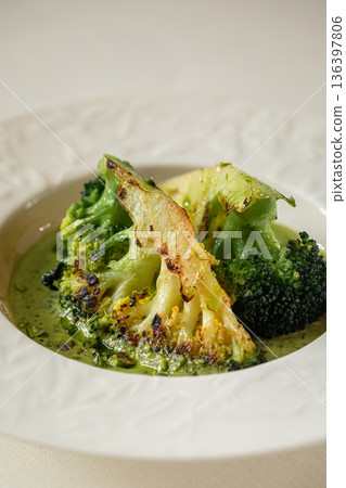 Roasted broccoli with creamy green sauce 136397806