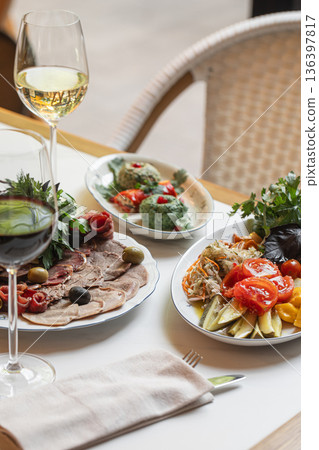 Restaurant cold appetizers with meat salads and wine 136397817