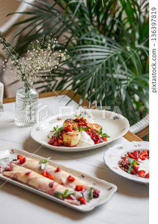 Cottage cheese pancakes with berries and cream 136397819