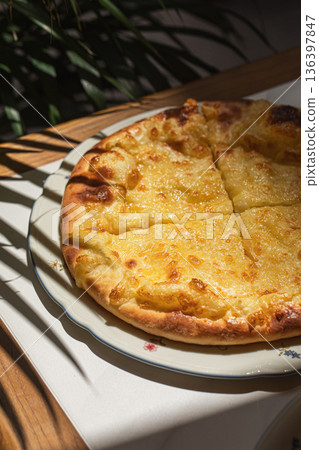 Traditional Georgian khachapuri with melted cheese Traditional Georgian khachapuri with melted cheese 136397847