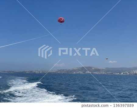 Parasaling over the sea . Holiday activity Parasaling in Kusadasi, Turkey Parasaling over the sea . Holiday activity Parasaling in Kusadasi, Turkey 136397889