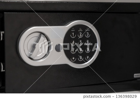 Modern black electronic safe displaying a digital keypad with visible READY, LOW BATTERY, PROCEED indicators, offering secure storage and robust asset protection for valuables 136398029