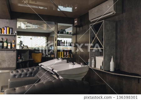 Modern barbershop interior with shampoo wash stations and styling area. Professional salon workspace, clean grooming environment, contemporary design, barber service concept. Modern barbershop interior with shampoo wash stations and styling area. Professional salon workspace, clean grooming environment, contemporary design, barber service concept. 136398301