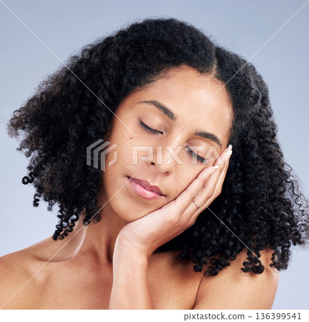 Woman touching face, beauty and natural skincare, cosmetics and curly hair on studio background. Haircare, wellness and self care, healthy skin glow and peace with female model and dermatology Woman touching face, beauty and natural skincare, cosmetics and curly hair on studio background. Haircare, wellness and self care, healthy skin glow and peace with female model and dermatology 136399541