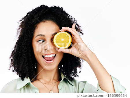 Citrus, lemon and eye of woman with fashion for organic wellness isolated in a studio white background. Diet, fruit and happy or excited young person with crazy vitamin c energy, health and detox Citrus, lemon and eye of woman with fashion for organic wellness isolated in a studio white background. Diet, fruit and happy or excited young person with crazy vitamin c energy, health and detox 136399634