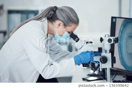 Senior woman, science and lab microscope for research and work for medical analysis. Scientist, investigation and laboratory expert with covid and healthcare report for virus monitoring and data 136399642