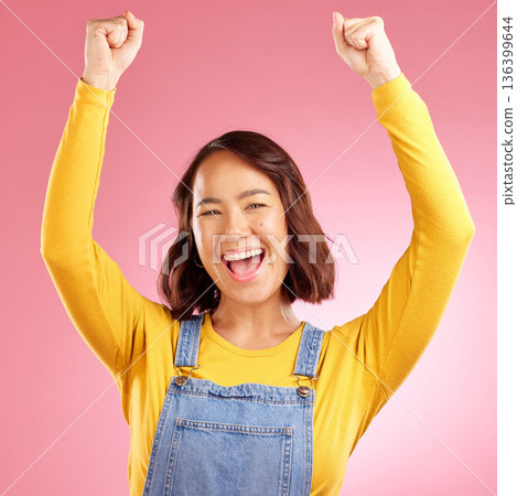 Happy, celebration and success with portrait of asian woman in studio for party, winner or motivation. Wow, freedom and prize with face of person cheering in pink background for yes, bonus or excited Happy, celebration and success with portrait of asian woman in studio for party, winner or motivation. Wow, freedom and prize with face of person cheering in pink background for yes, bonus or excited 136399644