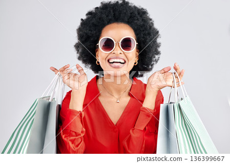 Happy black woman, face and shopping bags for fashion or style against a white studio background. Portrait of African female person, customer or shopper smile for discount, sale or deal in happiness Happy black woman, face and shopping bags for fashion or style against a white studio background. Portrait of African female person, customer or shopper smile for discount, sale or deal in happiness 136399667