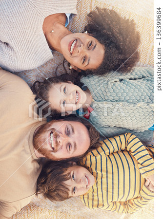 Portrait, happy family and top view on carpet in home for bonding together. Face, smile and parents with children on floor, interracial mother and father with kids, love and care for quality time 136399684
