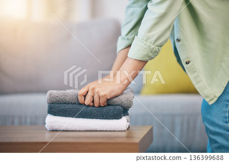 Hands, home and laundry on living room table for hygiene, cleaning and folding for housework in morning. Woman, fabric and cotton towel on desk for organized house, service and routine in apartment Hands, home and laundry on living room table for hygiene, cleaning and folding for housework in morning. Woman, fabric and cotton towel on desk for organized house, service and routine in apartment 136399688