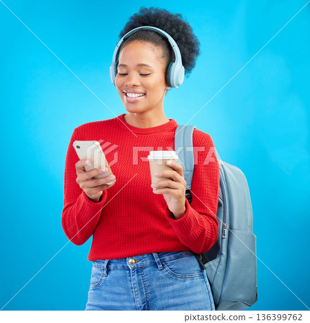 Phone music, student or happy woman reading education article, online university post and listening to radio podcast. Audio headphones, cellphone or college person on coffee break on blue background Phone music, student or happy woman reading education article, online university post and listening to radio podcast. Audio headphones, cellphone or college person on coffee break on blue background 136399762