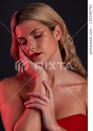 Beauty, makeup and wellness with a model woman in studio on a dark background wearing red clothes. Face, luxury and cosmetics with a young female person posing eyes closed.for elegant fashion 136399791