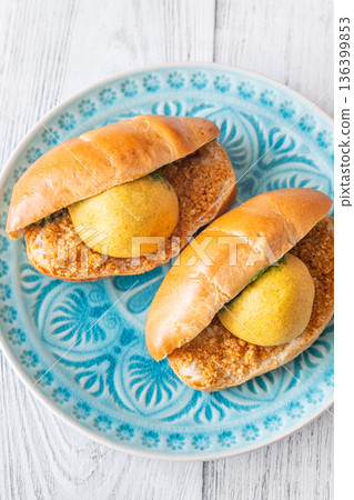 Vada Pav Indian street food served on blue plate in bright overhead composition 136399853