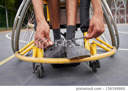 Fitness, wheelchair and man tie shoes ready for training, exercise and workout on outdoor court. Sports, start and male person with disability tying sneakers for performance, wellness and challenge Fitness, wheelchair and man tie shoes ready for training, exercise and workout on outdoor court. Sports, start and male person with disability tying sneakers for performance, wellness and challenge 136399868