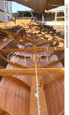 Planking Finishing Inside Hull With Bright Light And Clean Seams, Finisher Smoothing Joints And Applying Sealant, Close View Of Grain And Tools, Calm Professional Finishing Mood 136399871
