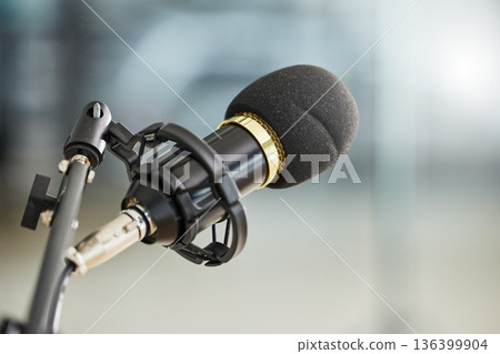 Background, closeup and microphone for podcast, radio interview and audio in recording studio. Sound gear, voice over production and broadcast of talk show, live stream communication and music media 136399904