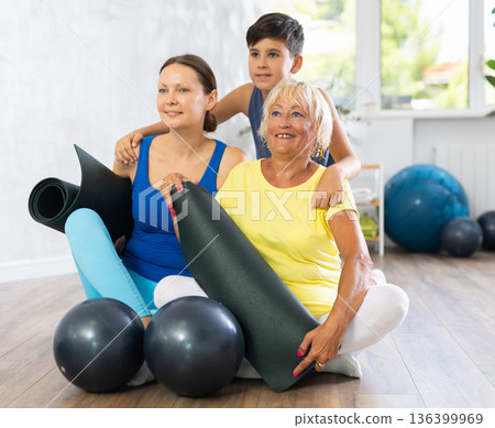Group of people at workout in yoga class group photo with sports equipment Group of people at workout in yoga class group photo with sports equipment 136399969
