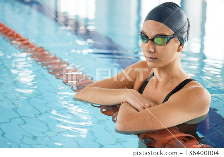 Swimming, thinking and a woman in a pool for training, competition or fitness. Idea, serious and a professional athlete swimmer or girl in the water for exercise, cardio or sports for health Swimming, thinking and a woman in a pool for training, competition or fitness. Idea, serious and a professional athlete swimmer or girl in the water for exercise, cardio or sports for health 136400004