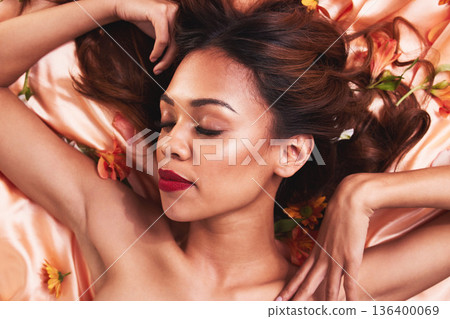 Top view, cosmetics and woman in bed with flowers for glow or dermatology with luxury facial. Cosmetology, beauty and face with girl wearing makeup for natural grooming or self care for spa treatment Top view, cosmetics and woman in bed with flowers for glow or dermatology with luxury facial. Cosmetology, beauty and face with girl wearing makeup for natural grooming or self care for spa treatment 136400069