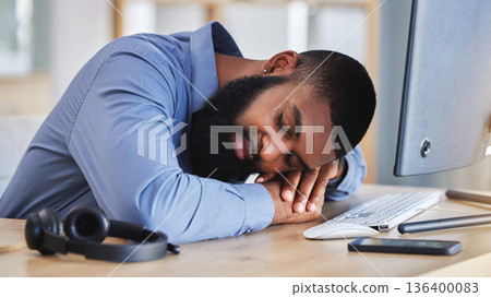 Call center, tired business man and sleeping at desk with burnout, fatigue and low energy in telemarketing office. Lazy, depressed and stress of african sales consultant taking a nap in CRM agency 136400083